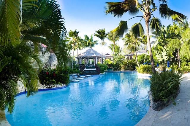 The sunlit pool, gazebo and tropical gardens at Claridges 3