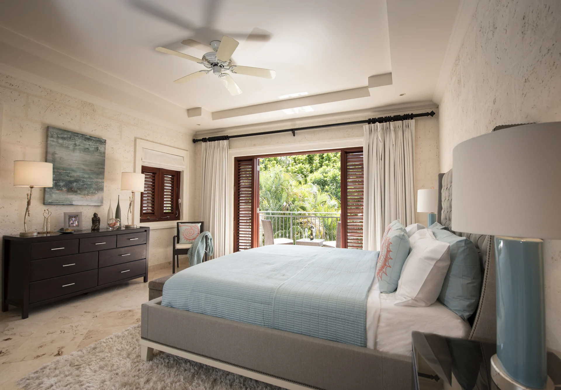 Bright ensuite bedroom at Claridges 3 with French doors opening onto the tropical garden