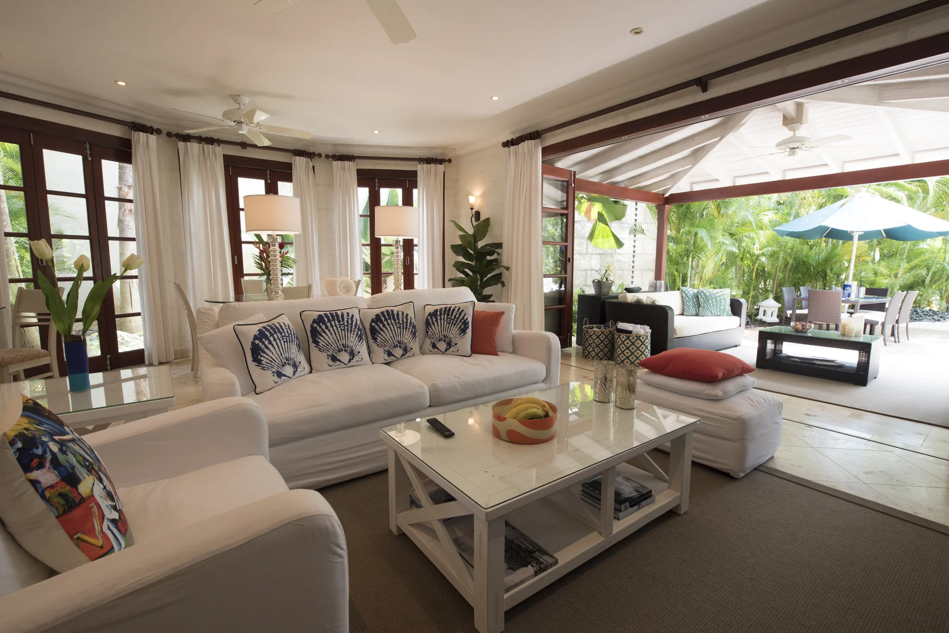Claridges 3 open-plan living room opening onto a covered terrace and tropical garden